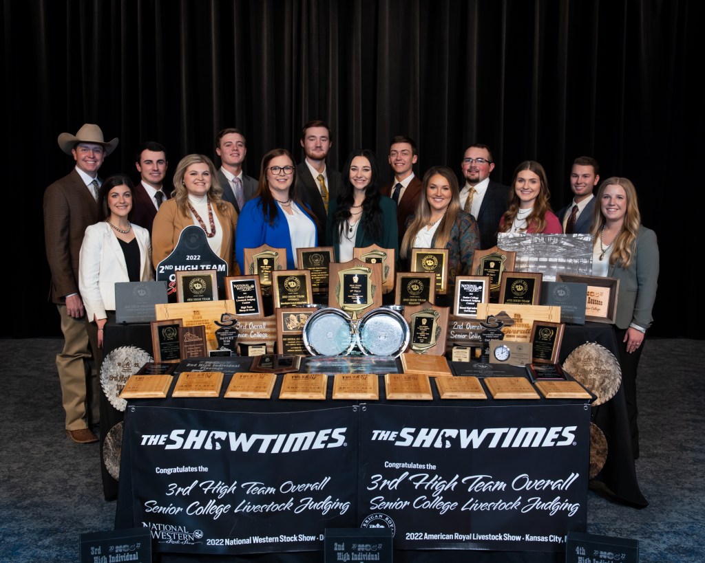 Livestock judging team with table full of awards